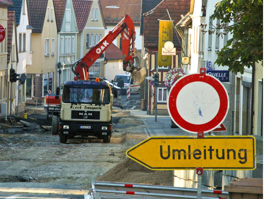 Umleitungsschild mit Baustelle im Hintergrund